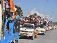 Supporters of Congress candidate Tanzil Hussain from the Samaguri constituency participate in a roadshow during an election campaign rally a...