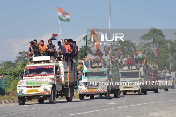 Supporters of Congress candidate Tanzil Hussain from the Samaguri constituency participate in a roadshow during an election campaign rally a...