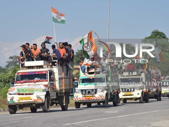 Supporters of Congress candidate Tanzil Hussain from the Samaguri constituency participate in a roadshow during an election campaign rally a...