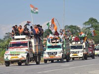 Supporters of Congress candidate Tanzil Hussain from the Samaguri constituency participate in a roadshow during an election campaign rally a...