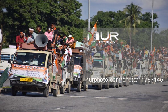 Supporters of Congress candidate Tanzil Hussain from the Samaguri constituency participate in a roadshow during an election campaign rally a...