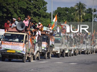 Supporters of Congress candidate Tanzil Hussain from the Samaguri constituency participate in a roadshow during an election campaign rally a...