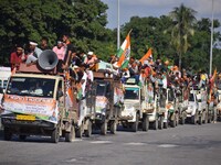 Supporters of Congress candidate Tanzil Hussain from the Samaguri constituency participate in a roadshow during an election campaign rally a...