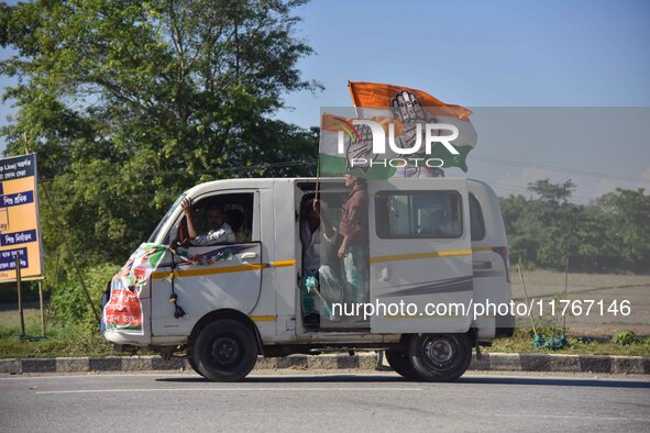 Supporters of Congress candidate Tanzil Hussain from the Samaguri constituency participate in a roadshow during an election campaign rally a...