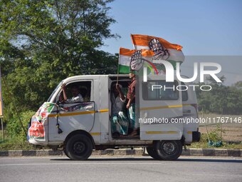 Supporters of Congress candidate Tanzil Hussain from the Samaguri constituency participate in a roadshow during an election campaign rally a...