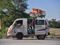 Supporters of Congress candidate Tanzil Hussain from the Samaguri constituency participate in a roadshow during an election campaign rally a...