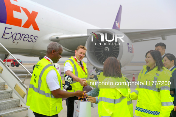 In Qingdao, China, on November 11, 2024, FedEx and airport staff present gifts to the crew. 