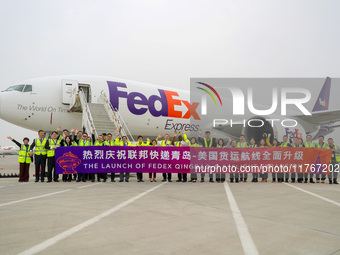 Flight crew members pose for a group photo with FedEx and airport personnel in Qingdao, China, on November 11, 2024. (