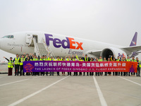 Flight crew members pose for a group photo with FedEx and airport personnel in Qingdao, China, on November 11, 2024. (