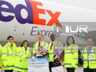 Flight crew members pose for a group photo with FedEx and airport personnel in Qingdao, China, on November 11, 2024. (