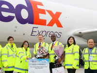 Flight crew members pose for a group photo with FedEx and airport personnel in Qingdao, China, on November 11, 2024. (