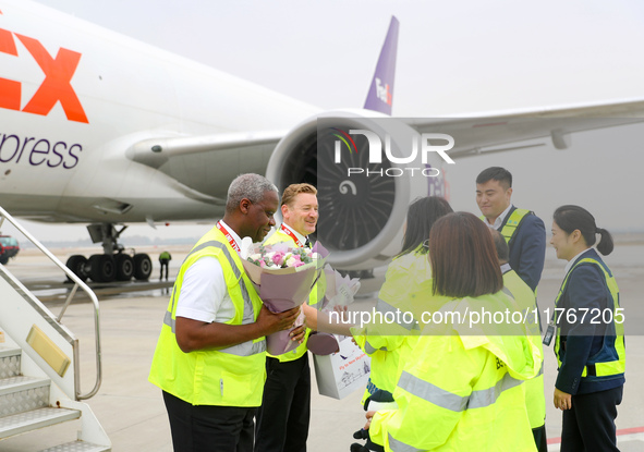 In Qingdao, China, on November 11, 2024, FedEx and airport staff present gifts to the crew. 