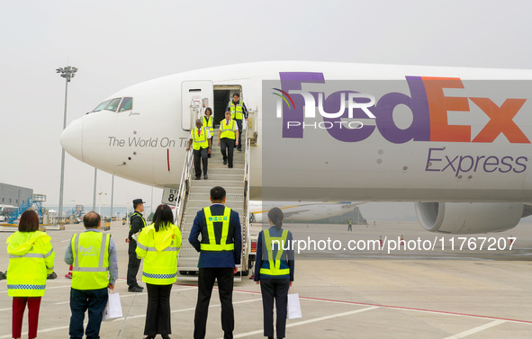 Crew members slowly step off the plane in Qingdao, China, on November 11, 2024. 