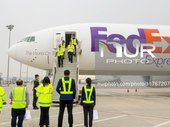 Crew members slowly step off the plane in Qingdao, China, on November 11, 2024. (