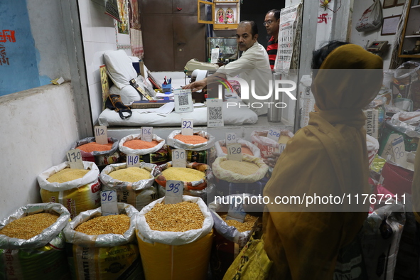 A customer buys pulses at a wholesale market in Kolkata, India, on November 11, 2024. India's consumer price inflation rises to a 14-month h...