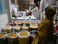 A customer buys pulses at a wholesale market in Kolkata, India, on November 11, 2024. India's consumer price inflation rises to a 14-month h...