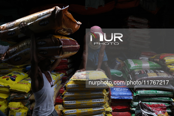 A laborer carries sacks filled with pulses at a wholesale market in Kolkata, India, on November 11, 2024. India's consumer price inflation r...