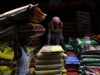 A laborer carries sacks filled with pulses at a wholesale market in Kolkata, India, on November 11, 2024. India's consumer price inflation r...