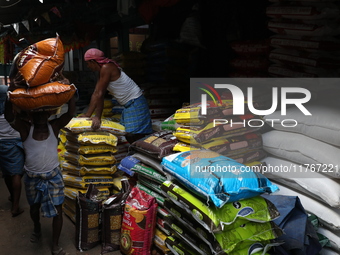 A laborer carries sacks filled with pulses at a wholesale market in Kolkata, India, on November 11, 2024. India's consumer price inflation r...