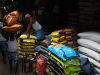 A laborer carries sacks filled with pulses at a wholesale market in Kolkata, India, on November 11, 2024. India's consumer price inflation r...