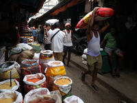 A laborer carries a sack filled with pulses at a wholesale market in Kolkata, India, on November 11, 2024. India's consumer price inflation...