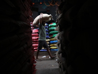 A laborer carries a sack filled with pulses at a wholesale market in Kolkata, India, on November 11, 2024. India's consumer price inflation...