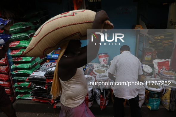 A laborer carries a sack filled with pulses at a wholesale market in Kolkata, India, on November 11, 2024. India's consumer price inflation...