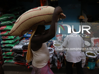 A laborer carries a sack filled with pulses at a wholesale market in Kolkata, India, on November 11, 2024. India's consumer price inflation...