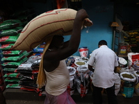 A laborer carries a sack filled with pulses at a wholesale market in Kolkata, India, on November 11, 2024. India's consumer price inflation...