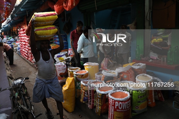 A laborer carries sacks filled with pulses at a wholesale market in Kolkata, India, on November 11, 2024. India's consumer price inflation r...