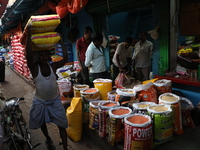 A laborer carries sacks filled with pulses at a wholesale market in Kolkata, India, on November 11, 2024. India's consumer price inflation r...