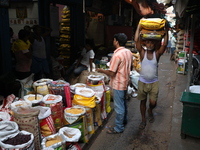 A laborer carries sacks filled with pulses at a wholesale market in Kolkata, India, on November 11, 2024. India's consumer price inflation r...