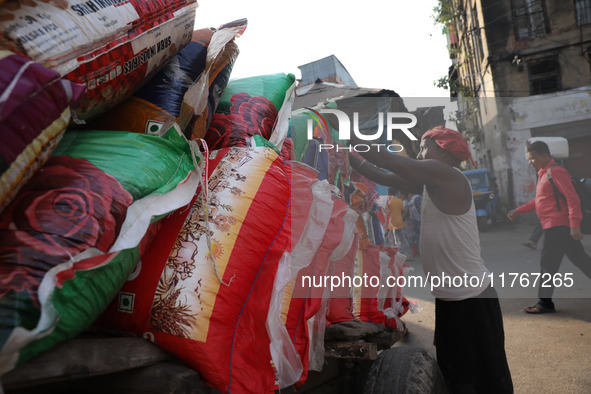 A laborer loads consumer goods onto a supply cart at a wholesale market in Kolkata, India, on November 11, 2024. India's consumer price infl...