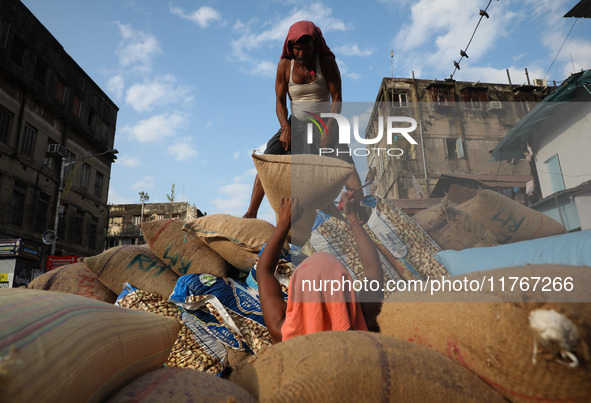 Labourers load consumer goods onto a supply cart at a wholesale market in Kolkata, India, on November 11, 2024. India's consumer price infla...