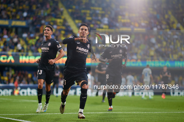 Ilias Akhomach of Villarreal CF celebrates after scoring the team's first goal next to his teammate Sergi Cardona and Gueye of Villarreal CF...