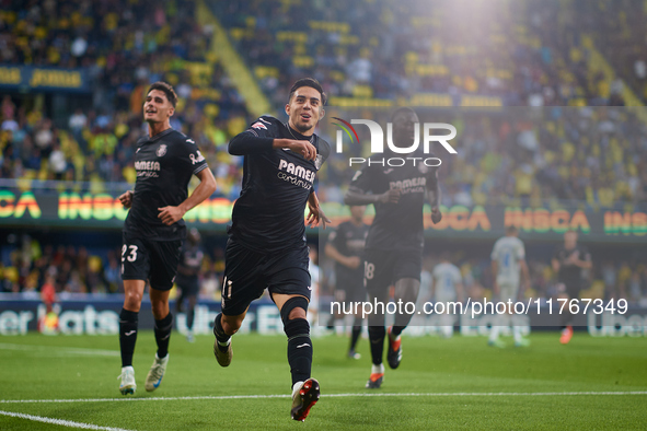 Ilias Akhomach of Villarreal CF celebrates after scoring the team's first goal next to his teammate Sergi Cardona and Gueye of Villarreal CF...