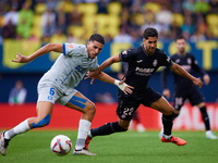 Ayoze (R) of Villarreal CF competes for the ball with Abdelkabir Abqar of Deportivo Alaves during the LaLiga EA Sports match between Villarr...