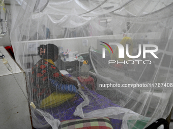 Patients suffering from dengue fever receive treatment inside the 'Shaheed Suhrawardy' Medical College Hospital in Dhaka, Bangladesh, on Nov...