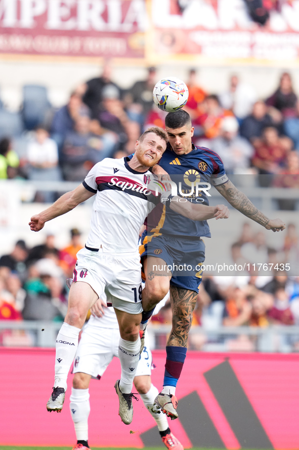 Gianluca Mancini of AS Roma and Tommaso Pobega of Bologna FC compete for the ball during the Serie A Enilive match between AS Roma and Bolog...