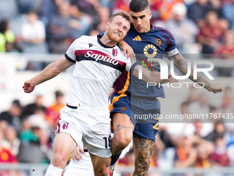 Gianluca Mancini of AS Roma and Tommaso Pobega of Bologna FC compete for the ball during the Serie A Enilive match between AS Roma and Bolog...