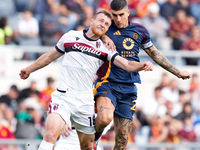 Gianluca Mancini of AS Roma and Tommaso Pobega of Bologna FC compete for the ball during the Serie A Enilive match between AS Roma and Bolog...