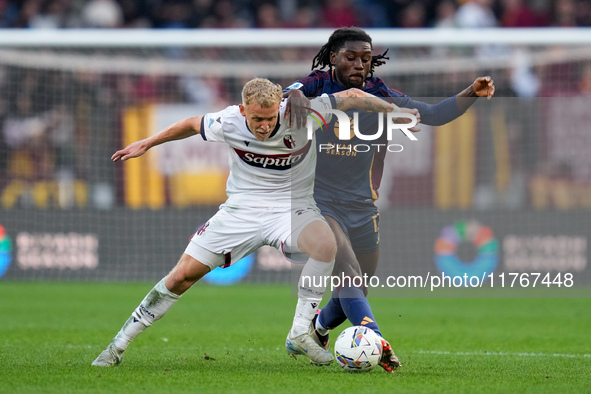 Jens Odgaard of Bologna FC and Manu Kone' of AS Roma compete for the ball during the Serie A Enilive match between AS Roma and Bologna FC at...