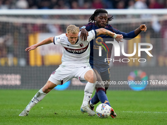 Jens Odgaard of Bologna FC and Manu Kone' of AS Roma compete for the ball during the Serie A Enilive match between AS Roma and Bologna FC at...