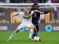 Jens Odgaard of Bologna FC and Manu Kone' of AS Roma compete for the ball during the Serie A Enilive match between AS Roma and Bologna FC at...