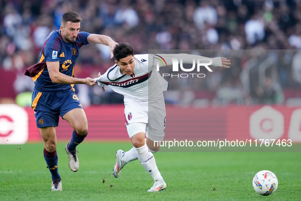 Bryan Cristante of AS Roma and Santiago Castro of Bologna FC compete for the ball during the Serie A Enilive match between AS Roma and Bolog...