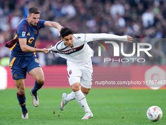 Bryan Cristante of AS Roma and Santiago Castro of Bologna FC compete for the ball during the Serie A Enilive match between AS Roma and Bolog...