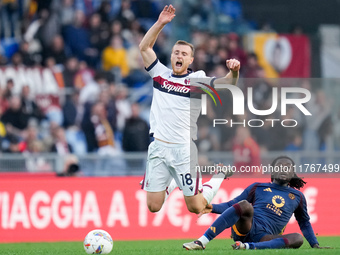 Manu Kone' of AS Roma and Tommaso Pobega of Bologna FC compete for the ball during the Serie A Enilive match between AS Roma and Bologna FC...