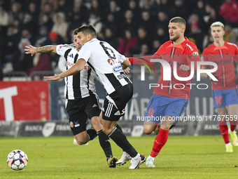 Iulian Cristea and Daniel Birligea are in action during the Superliga match between Universitatea Cluj and FCSB at Cluj Arena on November 10...