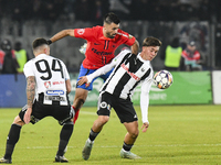 Valentin Cretu and Adrian Bota are in action during the Superliga match between Universitatea Cluj and FCSB at Cluj Arena in Cluj, Romania,...