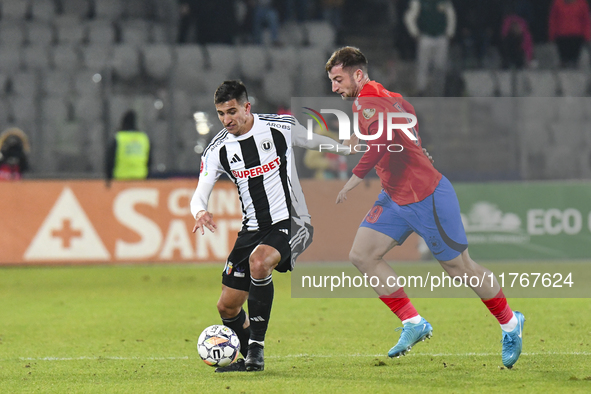 Lucas Gabriel Masoero and Daniel Popa are in action during the Superliga match between Universitatea Cluj and FCSB at Cluj Arena in Cluj, Ro...